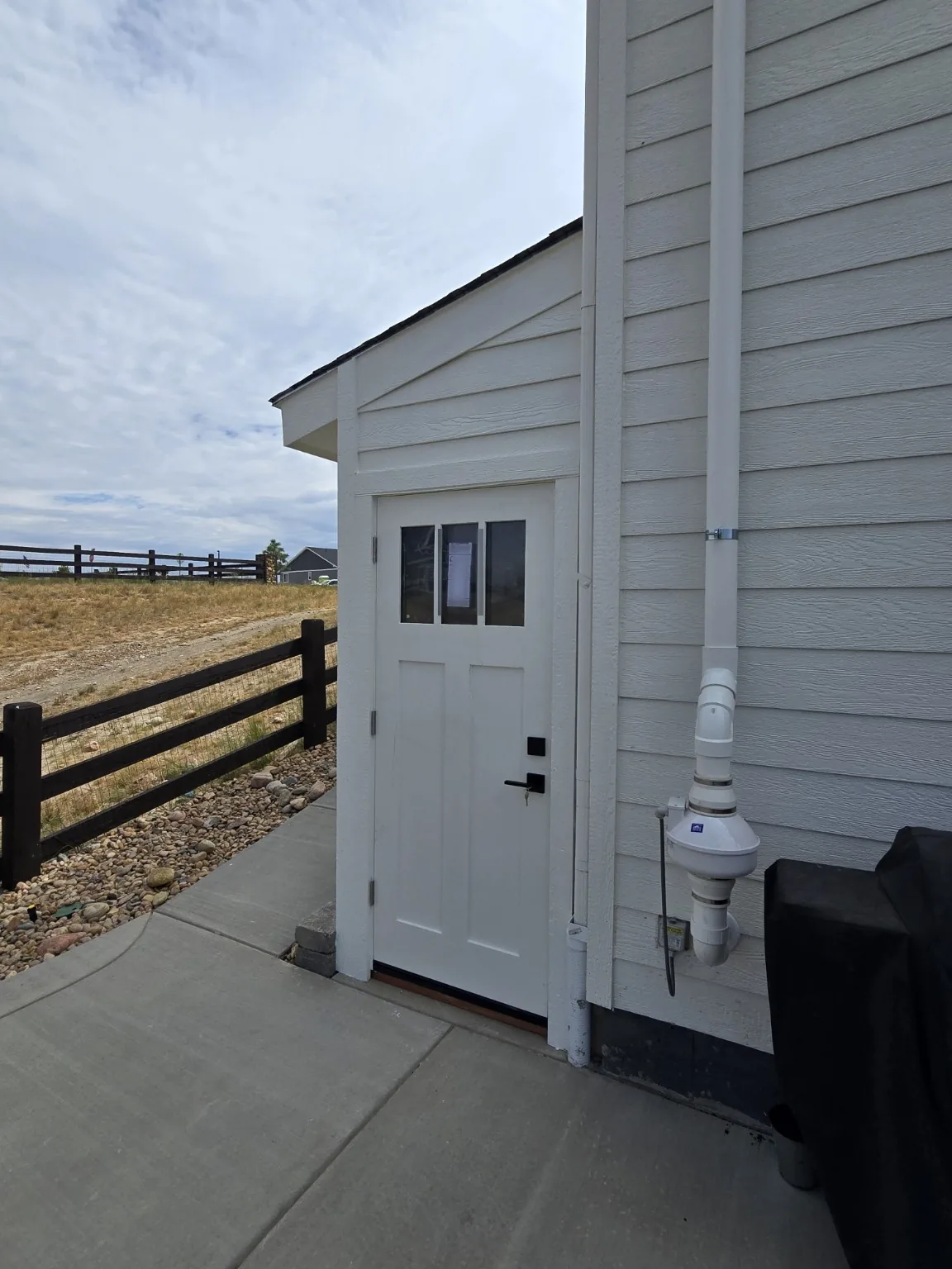 Three-lite glazed exterior entry door installed on the Castle Rock basement entrance enclosure