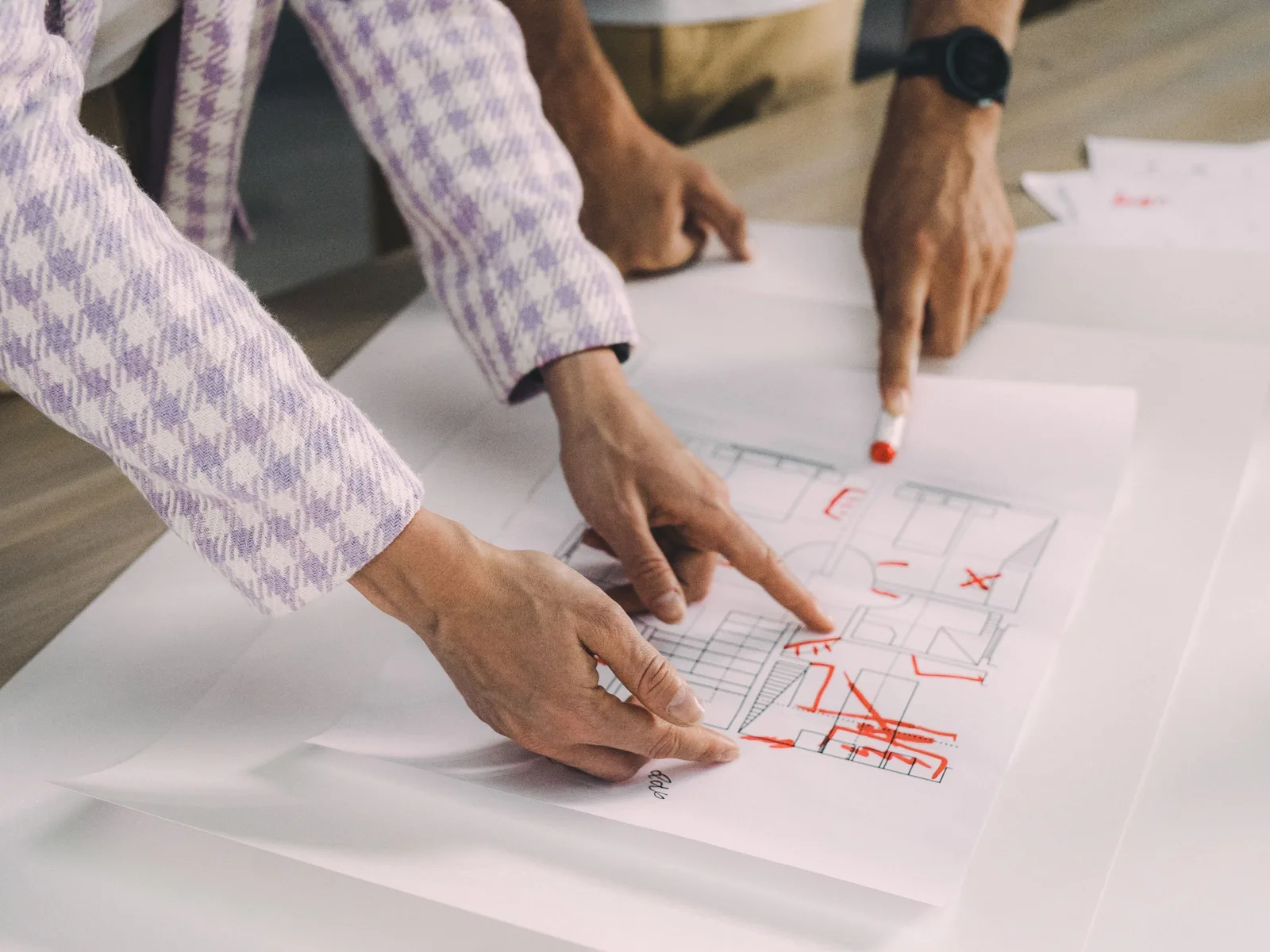 Residential plans and material samples being reviewed during project planning.