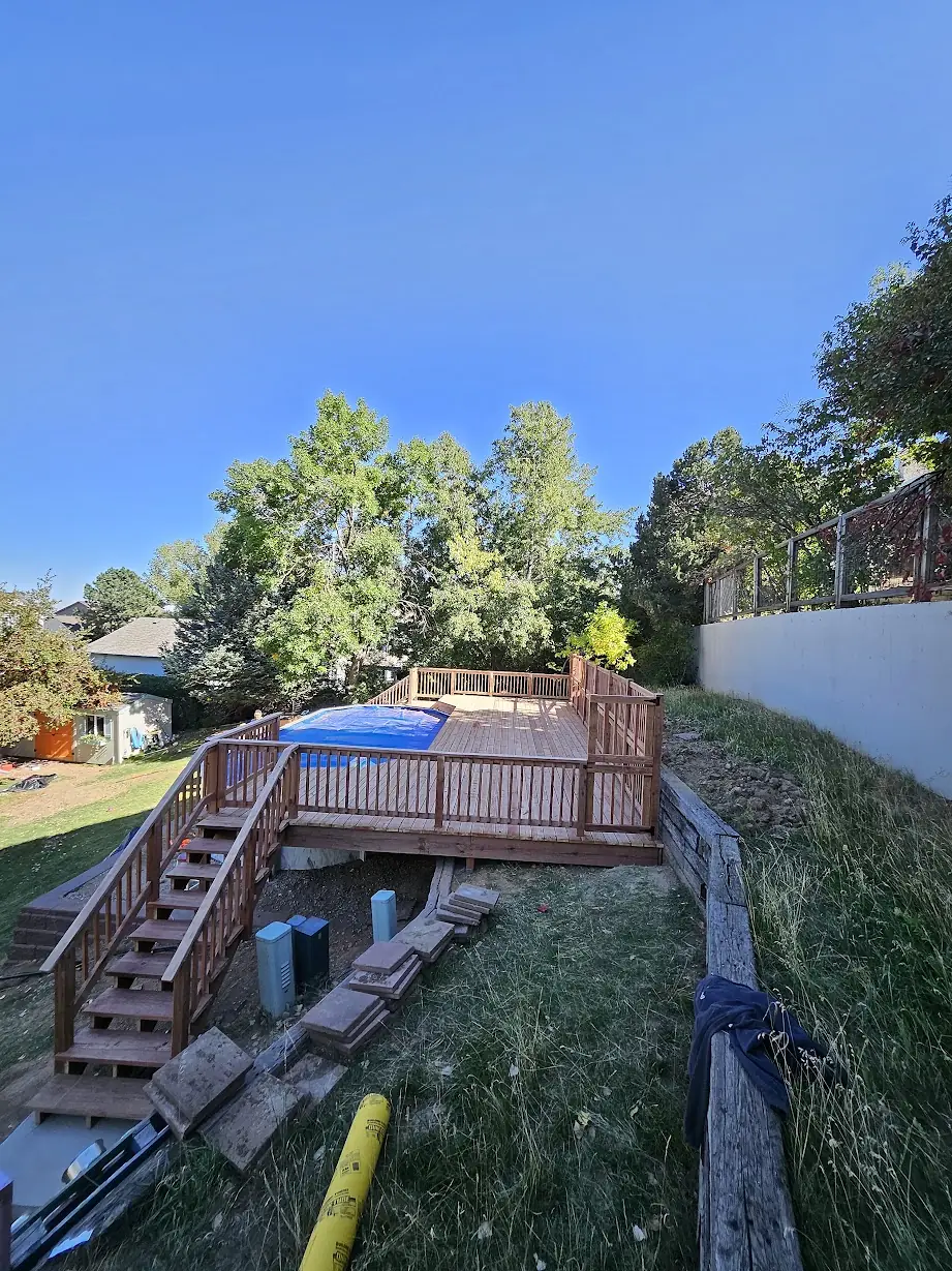 Wide view of the completed Lakewood pool deck with wood railings and stairs