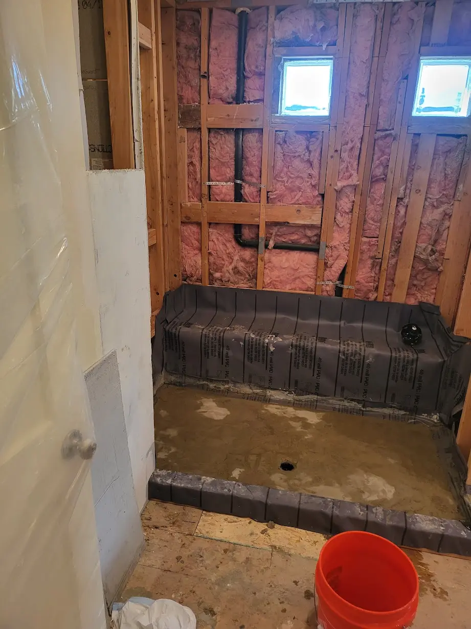 Bathroom shower area after demolition and preparation for the revised layout