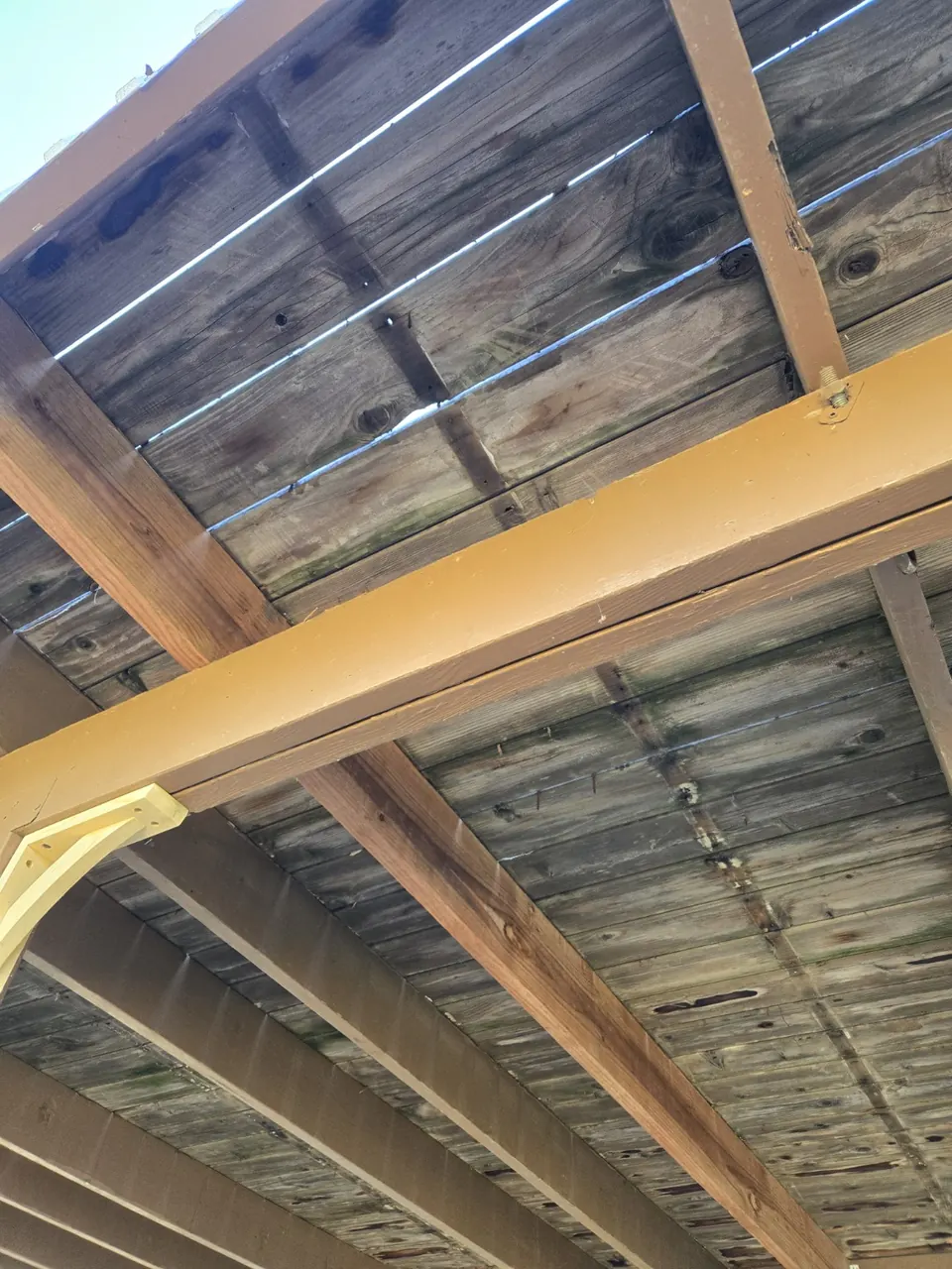 Underside view of deck framing and beams during the repair