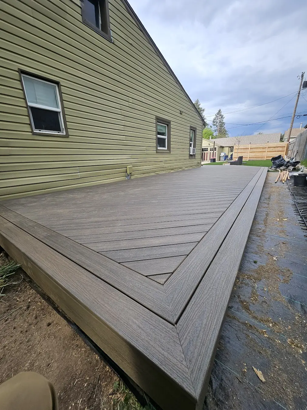 Detailed Trex picture-frame border and mitered corner on a ground-level deck in Littleton