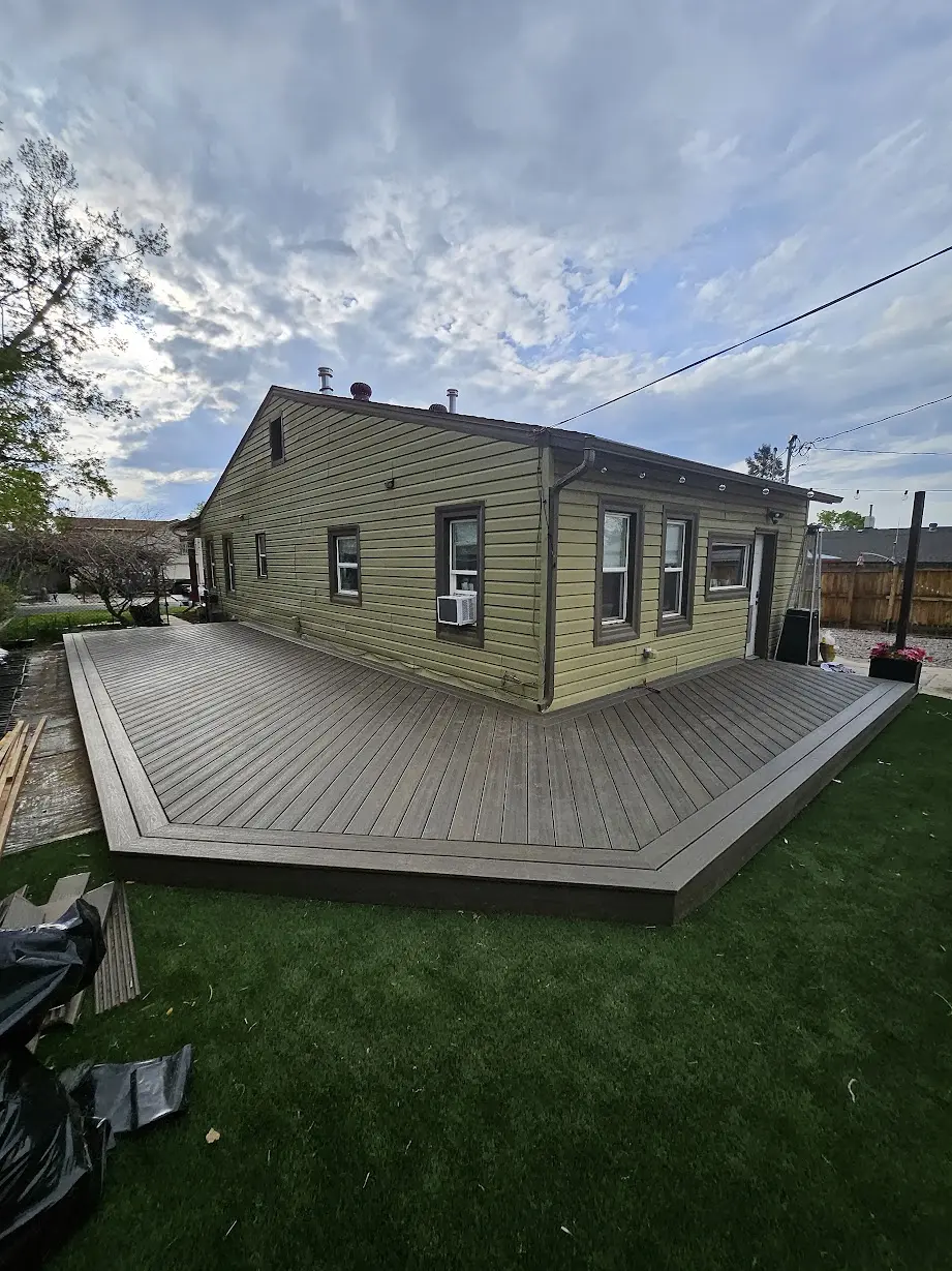 Completed ground-level Trex composite deck wrapping around a Littleton home