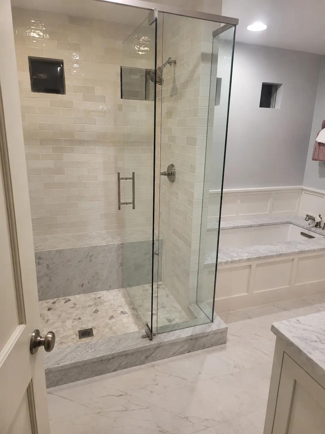 Completed glass-enclosed shower and separate bathtub in a Denver bathroom remodel